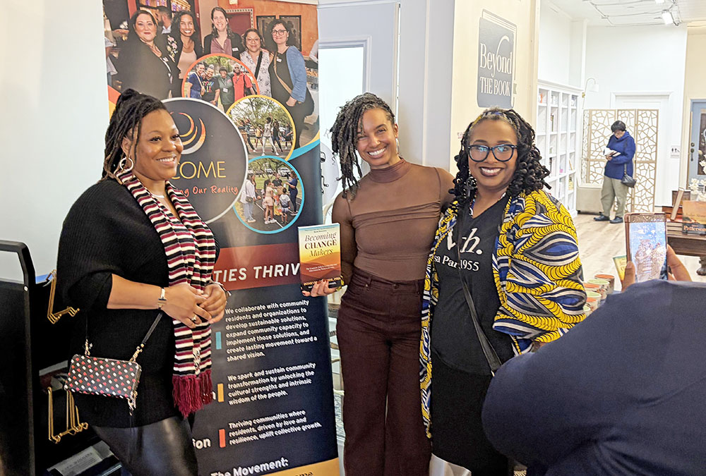 From left, Shemeka Woodson, Dominica McBride and Keisha Farmer-Smith pose for a photo in front of the BECOME banner at the Becoming Change Makers Book signing and women's event at Beyond the Book on Saturday, March 7. (Jamilah Lewis/H-F Chronicle)