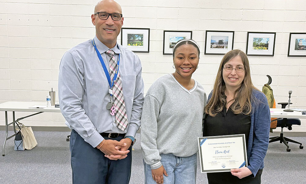 Teacher Elana Reid, right, received the #Above and Beyond honor from District 161. She was nominated by student Alani Jeffries, center. Joining them is Superintendent Dana Smith. (Marilyn Thomas/H-F Chronicle)