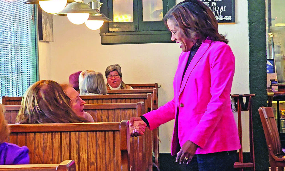 Democratic Party nominee for the 2nd District seat in Congress Donna Miller greets patrons at Flossmoor Station on March 18, the day after she won the primary election over nine competitors. (Eric Crump/H-F Chronicle)