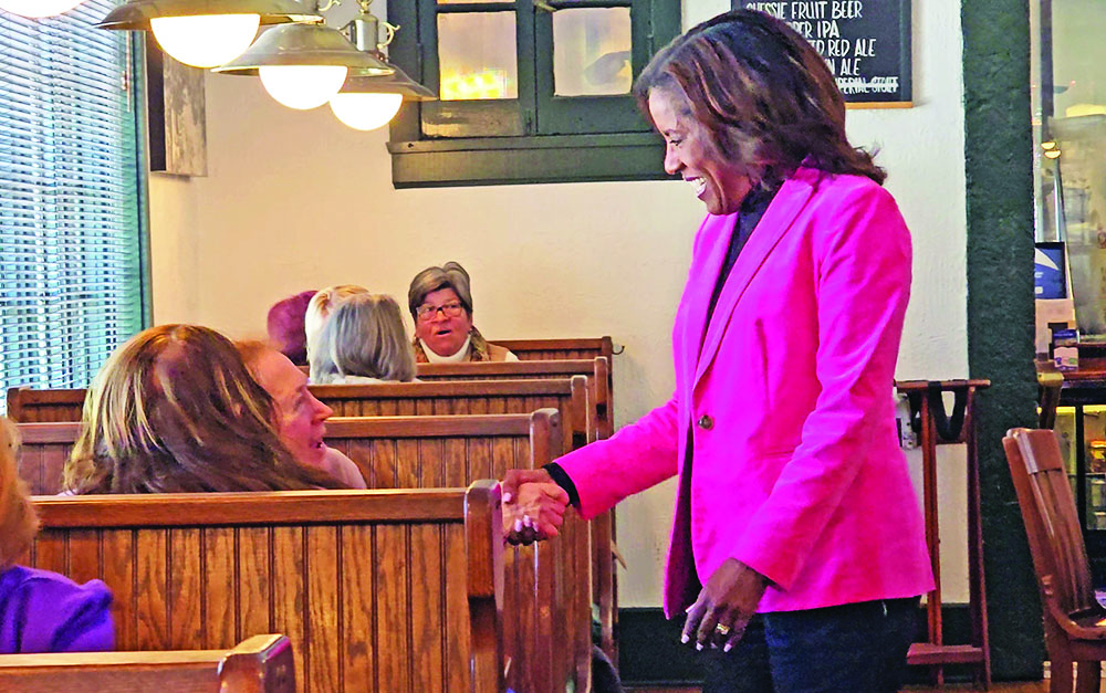 Democratic Party nominee for the 2nd District seat in Congress Donna Miller greets patrons at Flossmoor Station on March 18, the day after she won the primary election over nine competitors. (Eric Crump/H-F Chronicle)