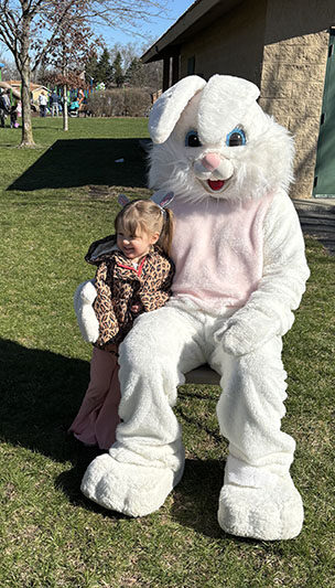 Marcy Swinford, 3, got her picture taken with the Easter Bunny after the egg hunt. (Marilyn Thomas/H-F Chronicle)