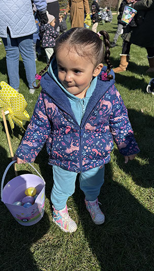 Jahlyne Gonzalez, 2, shows off her eggs collected Saturday, March 28. (Marilyn Thomas/H-F Chronicle)