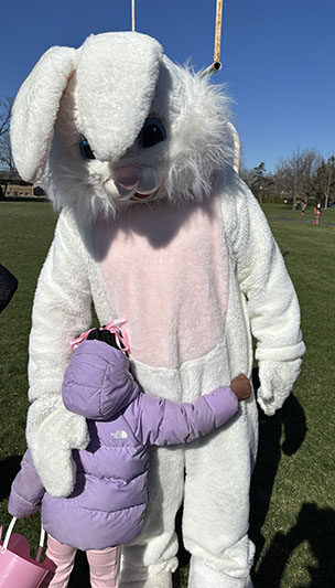 The Easter Bunny gets a special hug before the start of the annual lucky egg hunt at Apollo Park. (Marilyn Thomas/H-F Chronicle)