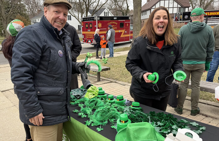 Harry Osterman, a Donna Miller campaign staffer, getting Saint Patrick’s Day gear from Flossmoor Community Engagement Manager Stephanie Wright before the parade. (Nick Ulanowski / H-F Chronicle)