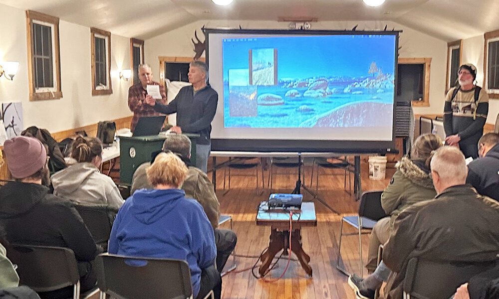 Izaak Walton Preserve President John Brinkman, center, welcomes preserve members before turning over the meeting to Tristan Shaw, right, who talked about native plants. (Jon Bannister/H-F Chronicle)