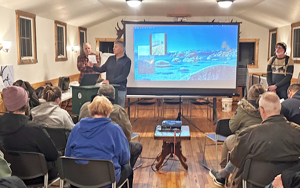 Izaak Walton Preserve President John Brinkman, center, welcomes preserve members before turning over the meeting to Tristan Shaw, right, who talked about native plants. (Jon Bannister/H-F Chronicle)