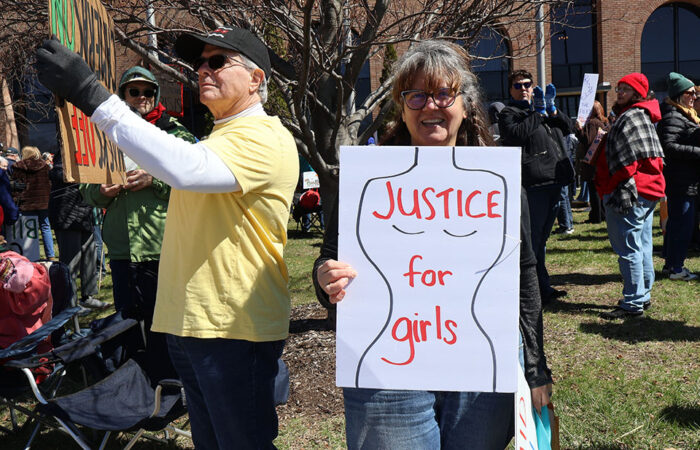 Katherine Herrman holds a sign reading “Justice for girls” during Saturday’s rally in Homewood. (Nuha Abdessalaem/H-F Chronicle)