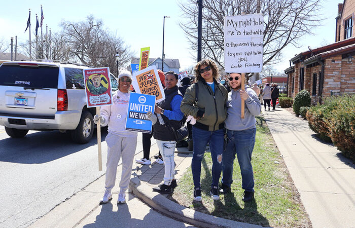 Renada Hardy and Penny Lee-Cox stand with Jonae Spinks and Josef Stepp along Harwood Avenue, signs up as traffic moves past them. (Nuha Abdessalam/H-F Chronicle)