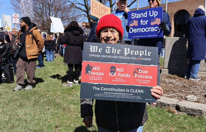 Cheryl Gansauer stands near the Homewood Veterans Memorial during Saturday’s rally, where she said, “Let’s see what this produces.” (Nuha Abdessalam/H-F Chronicle)