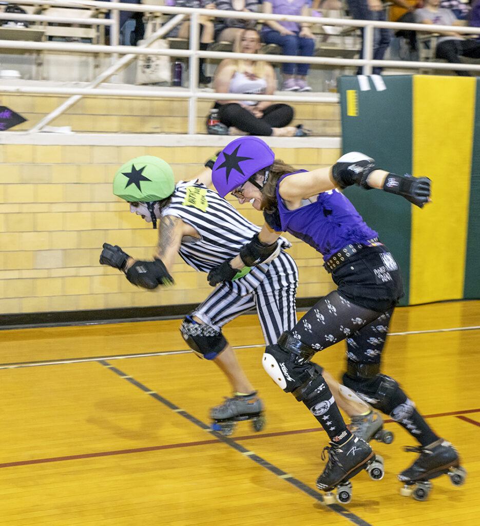 Opposing jammers Beat-Her Juice, left, and Sugar take off from the starting line at a Chicago Knockouts Roller Derby bout on April 15. (Colin Thomas/Thomas Photographic Services)
