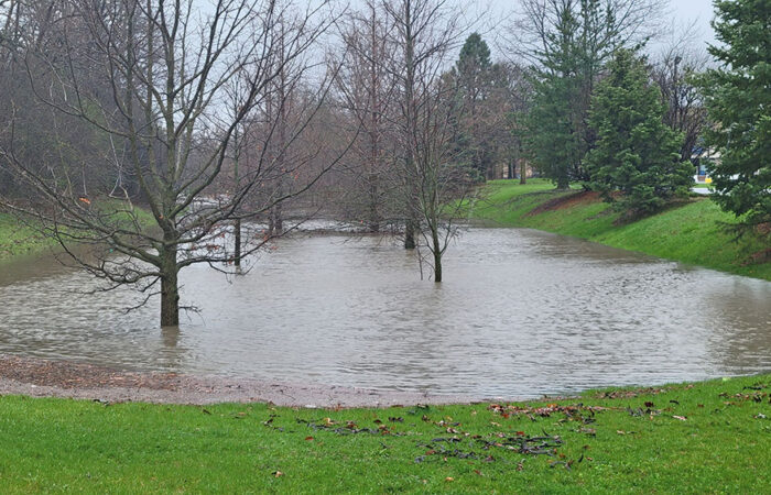 The detention basin east of Governors Highway, formerly part of Crescent Road, is nearly full at about 11:30 a.m. Saturday. (Eric Crump/H-F Chronicle)