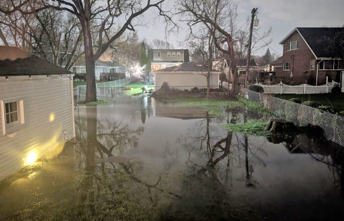 Trees are mirrored in a flooded back yard about 1 a.m. Saturday near Hickory Road and Loomis Avenue in Homewood. (Brian Bolek/provided)