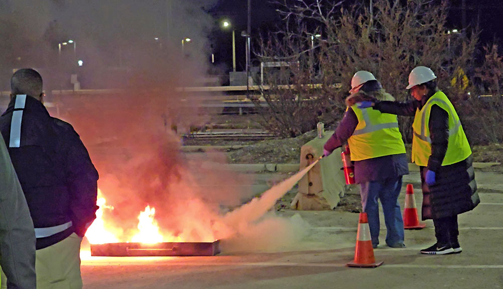Homewood CERT volunteers practice using a fire extinguisher in the parking lot behind the Homewood Fire Department. (Eric Crump/H-F Chronicle)