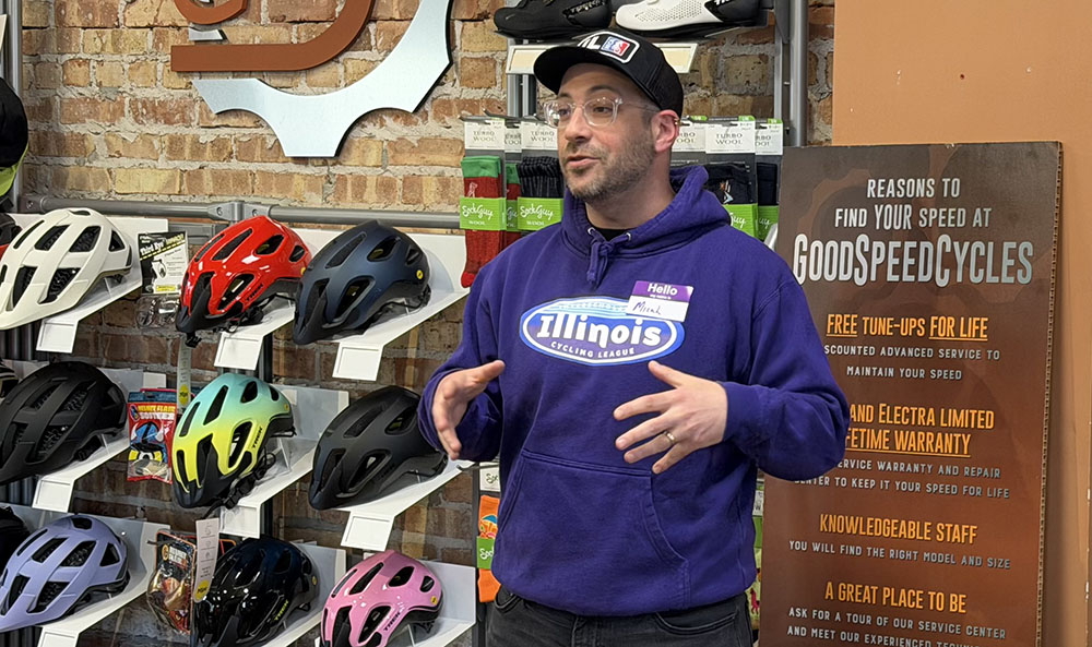 National Interscholastic Cycling Association (NICA) league director Micah Ariel-Roher talks to community members at GoodSpeed Cycles. (Nick Ulanowski / H-F Chronicle)