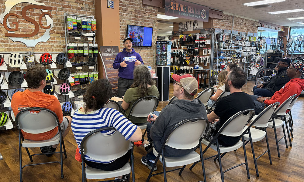 National Interscholastic Cycling Association (NICA) league director Micah Ariel-Roher describes his organization's programs at an information session hosted by GoodSpeed Cycles in Homewood. (Nick Ulanowski / H-F Chronicle)