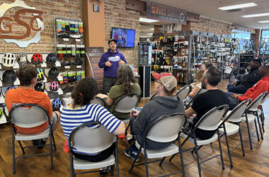 National Interscholastic Cycling Association (NICA) league director Micah Ariel-Roher describes his organization's programs at an information session hosted by GoodSpeed Cycles in Homewood. (Nick Ulanowski / H-F Chronicle)