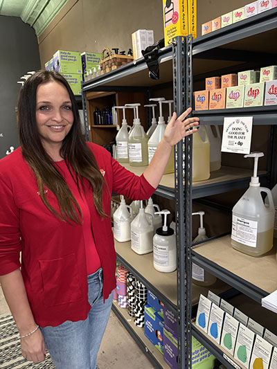 Kate Assaraf, founder of DIP, invites customers at Gaia's in Homewood to try the bar soaps for hair care. (Marilyn Thomas/H-F Chronicle)