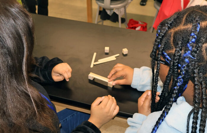 Students test different designs during a bridge-building activity at the Girls STEAM Celebration at Homewood-Flossmoor High School on April 11. (Nuha Abdessalam/H-F Chronicle)