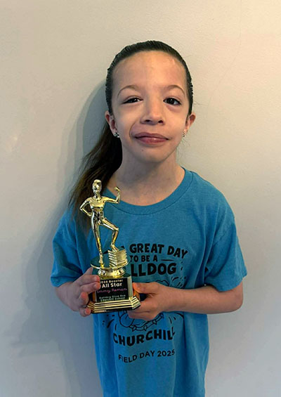 Emmy Roman with her trophy presented at the Churchill School Glow Run. Emmy was honored for raising $1,100 for the fundraiser. (Provided photo)