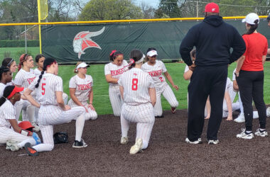 Homewood-Flossmoor softball coaches speak to the team after an 8-0 loss to Bradley-Bourbonnais April 15. (David P. Funk/H-F Chronicle)