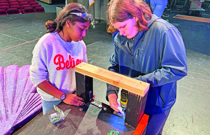 H-F production 9_CMYK Working on Neptune's throne is junior Aubrey Stewart holding the arm in place as freshman Sam Crocker prepares to drill in screws. (Marilyn Thomas/H-F Chronicle)
