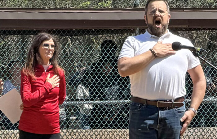 Opera singer Michael Cavalieri sings the national anthem during the opening day ceremony while standing next to HBSL president Angie Brandt. (Nick Ulanowski / H-F Chronicle)