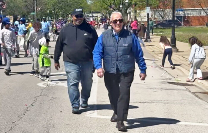 Homewood Mayor Rich Hofeld and Trustee Phil Mason walk the parade route along with youth baseball and softball teams. (Nick Ulanowski/H-F Chronicle)