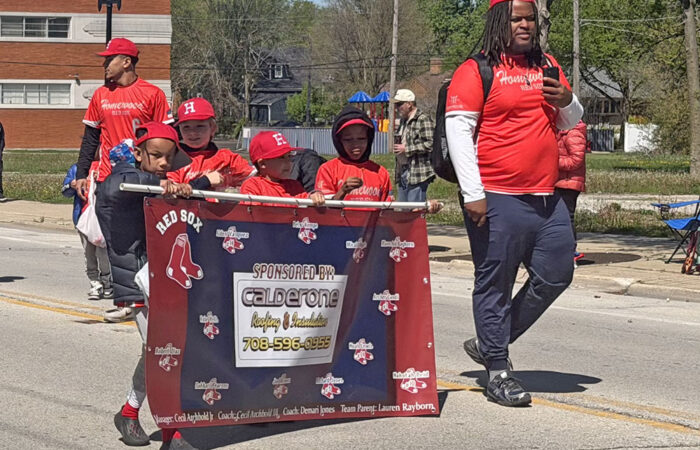 Red Sox players march in the HBSL opening day parade. (Nick Ulanowski/H-F Chronicle)