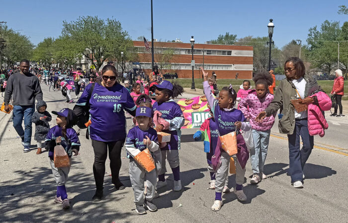 The Homewood K Pop Hitters fling candy to spectators along the parade route. (Nick Ulanowski/H-F Chronicle)