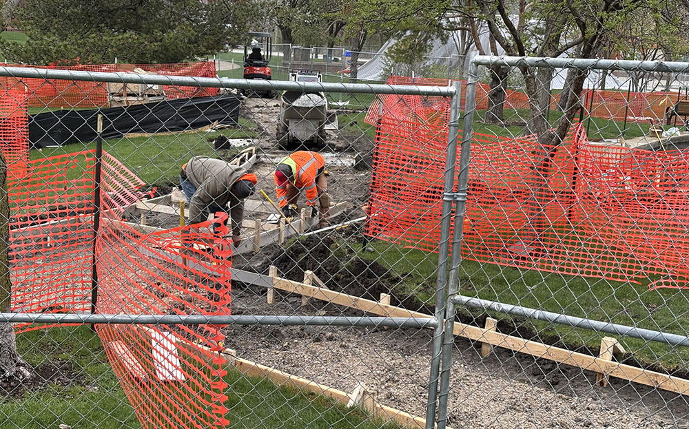 Crew members work on sidewalk replacement as part of the renovation of Irwin Park in Homewood. (Marilyn Thomas/H-F Chronicle)