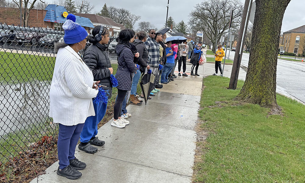 People lined up along Flossmoor Road to support the family of Kyran Smith, a Parker Junior High student who was killed in a car accident. Later they moved to the Parker parking lot as the funeral procession detoured. (Marilyn Thomas/H-F Chronicle)