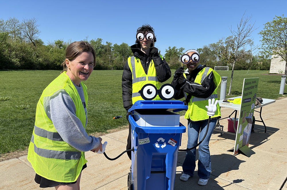 Flossmoor Mayor Michelle Nelson shakes hands with Loop, the mascot for the recycling educational program hosted by the Metropolitan Mayors Caucus. (Marilyn Thomas/H-F Chronicle)