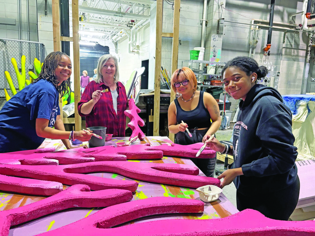 One of several painting crews, from left, senior Madison Jean, painting advisor Jane Nix, freshman Rayson Juan and senior DeAnna Williams prepare the underwater scenery for "The Little Mermaid" at Homewood-Flossmoor High School. Their work, and that of dozens of others, helps put the show together. (Marilyn Thomas/H-F Chronicle)