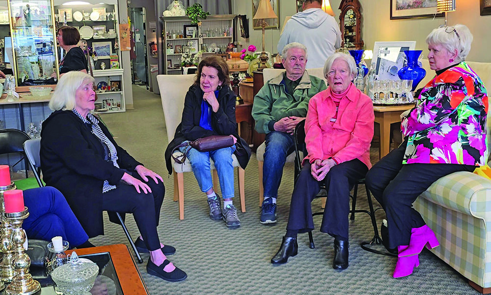 From left, the first Village Door manager Nancy Beele, regular customers Maristella and Juliano Gozzi, and volunteers Marie Sporny and Cheryl Van Kempema discuss their disappointment at the Cancer Support Center's decision to close the store. (Eric Crump/H-F Chronicle)