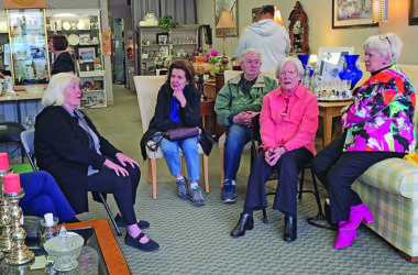 From left, the first Village Door manager Nancy Beele, regular customers Maristella and Juliano Gozzi, and volunteers Marie Sporny and Cheryl Van Kempema discuss their disappointment at the Cancer Support Center's decision to close the store. (Eric Crump/H-F Chronicle)