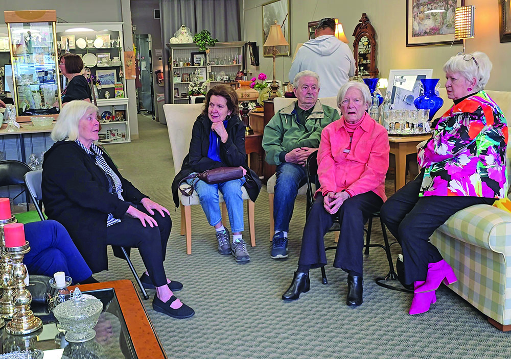 From left, the first Village Door manager Nancy Beele, regular customers Maristella and Juliano Gozzi, and volunteers Marie Sporny and Cheryl Van Kempema discuss their disappointment at the Cancer Support Center's decision to close the store. (Eric Crump/H-F Chronicle)