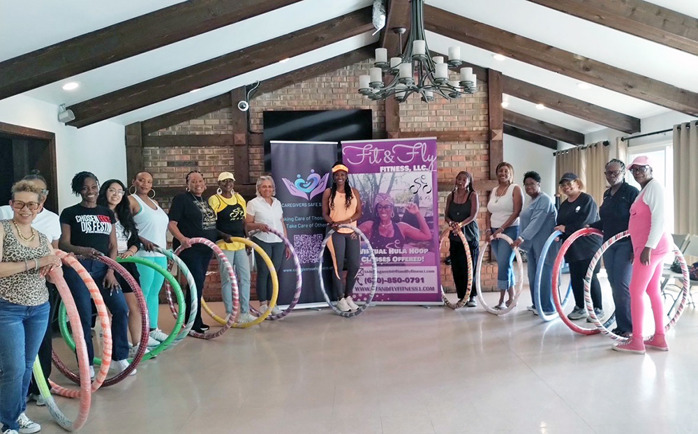 Caregivers exercise with hula hoops at a Caregivers' Safe Space support group meeting. (Provided photo)