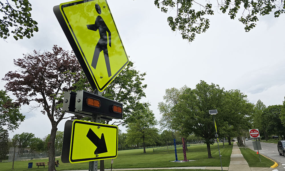 Flossmoor recently installed a new flashing crosswalk sign at Flossmoor Road and Brassie Avenue to help improve pedestrian safety near Flossmoor Park and Western Avenue School. (Eric Crump/H-F Chronicle)