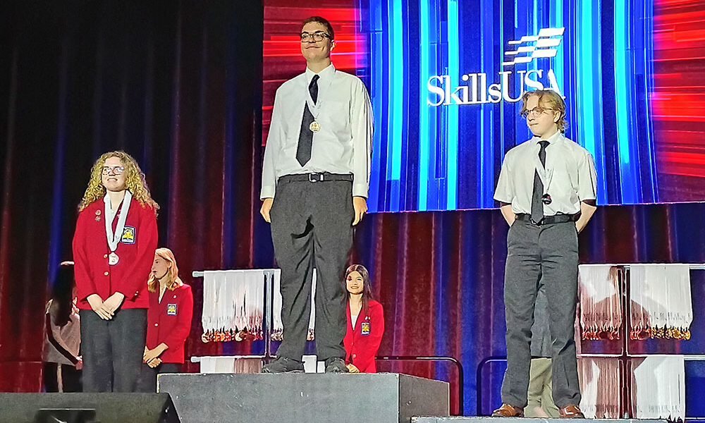 Charley Dieringer, a senior at Homewood-Flossmoor High School, stands on the top podium after winning first place in two competitions at SkillsUSA Illinois. (Provided photo)
