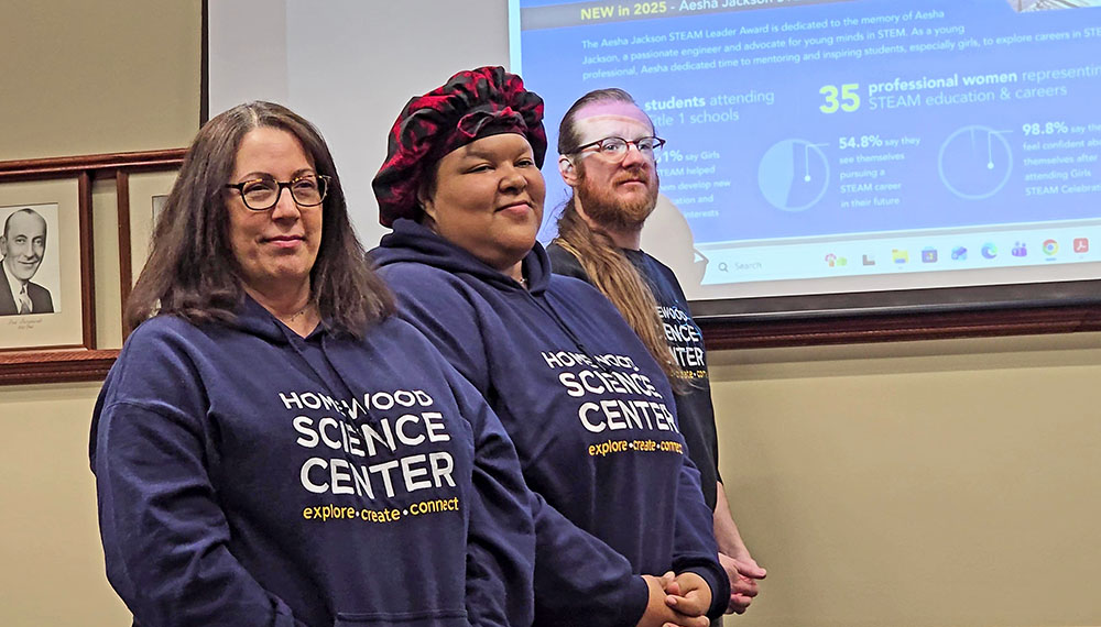 From left, Homewood Science Center staff members Janna Henry, Dominique Barksdale and Charlie Rohrer get a shout-out from Executive Director Edie Dobrez during the April 28 Homewood board meeting. (Eric Crump/H-F Chjronicle)