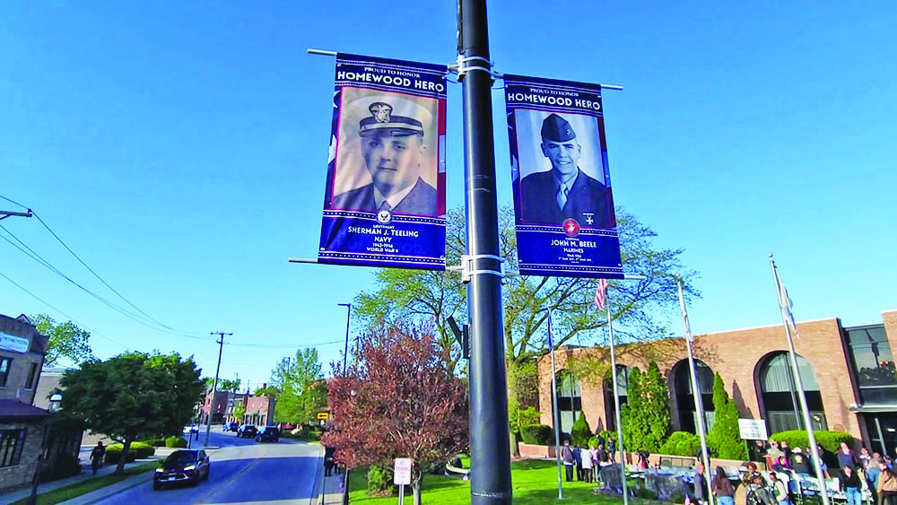 Banners honoring Sherman J. Teeling, who served in the Navy, and John M. Beele, who served in the Marines and currently serves as commander of the Wally Burns VFW Post, are located at the northeast corner of Harwood Avenue and Olive Road. (Eric Crump/H-F Chronicle)