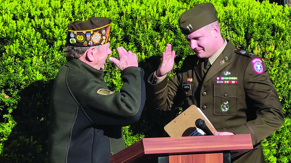 Wally Burns VFW Commander John Beele, left, and special guest Capt. John Acosta salute each other during the Homewood Hero Banner Program dedication ceremony on May 11. (Eric Crump/H-F Chronicle)