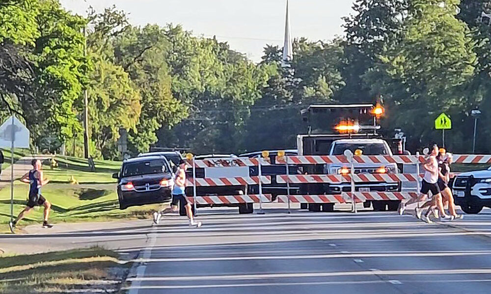 Runners cross Governors Highway at the north edge of the H-F High campus during the 2025 Hidden Gem Half Marathon. Road closures are expected to about the same as last year when the race is run in September. (Chronicle file photo)