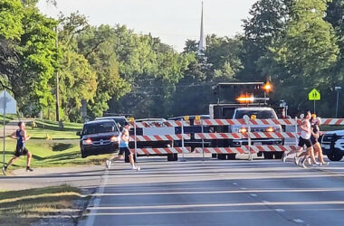Runners cross Governors Highway at the north edge of the H-F High campus during the 2025 Hidden Gem Half Marathon. Road closures are expected to about the same as last year when the race is run in September. (Chronicle file photo)