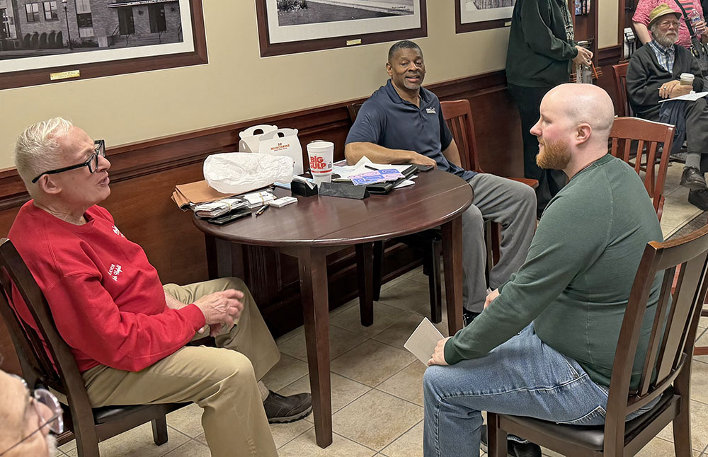 Mayor Rich Hofeld, left, speaks to Homewood resident Quincy Crump, right. Homewood Village Manager Napoleon Haney looks on. (Nick Ulanowski / H-F Chronicle)
