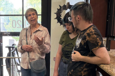 Jodi Libretti makes a case for restoring Pride flags in downtown Homewood while residents Carlie Rummel, center, and Sam Rummel, right, look on. Libretti brought the issue up at a recent village board meeting. (Nick Ulanowski / H-F Chronicle)
