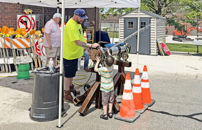 Hwd Public Works Open House -Ulanowski1_web Homewood Public Works street maintenance worker Dan Spain opens a valve to a water main for a curious youngster during the 2026 Public Works Open House. (Nick Ulanowski / H-F Chronicle)
