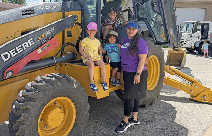 Hwd public works -Ulanowski6_web Yvette Lopez with her kids tour a tractor during the Homewood Public Works Open House on May 16. (Nick Ulanowski / H-F Chronicle)