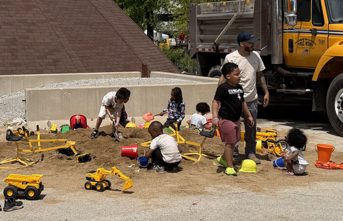 Hwd public works -Ulanowski7_web Youngsters enjoy playing in a mound of sand and with toy trucks meant to represent Homewood Public Works vehicles. (Nick Ulanowski / H-F Chronicle)
