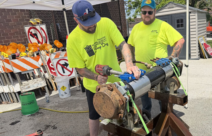 Hwd public works open -Ulanowski5_web Homewood Public Works street maintenance workers Dan Spain, left, and Bob Beuck operate a water main modulator during the annual open house on May 16. (Nick Ulanowski / H-F Chronicle)